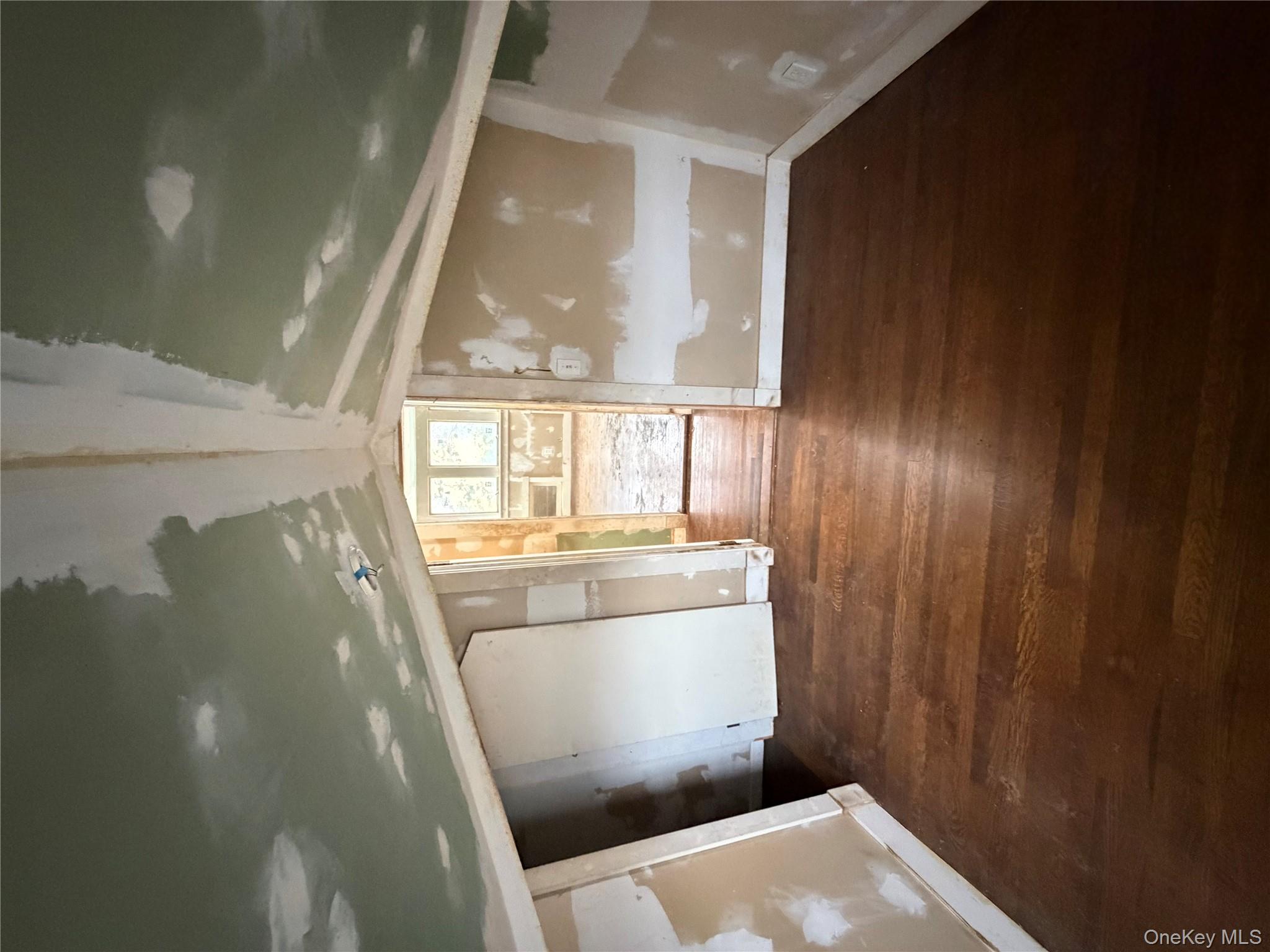244 Tibbetts Road Yonkers, NY 10705 - Photo 7 of 28 a view of an empty room with wooden floor and a window