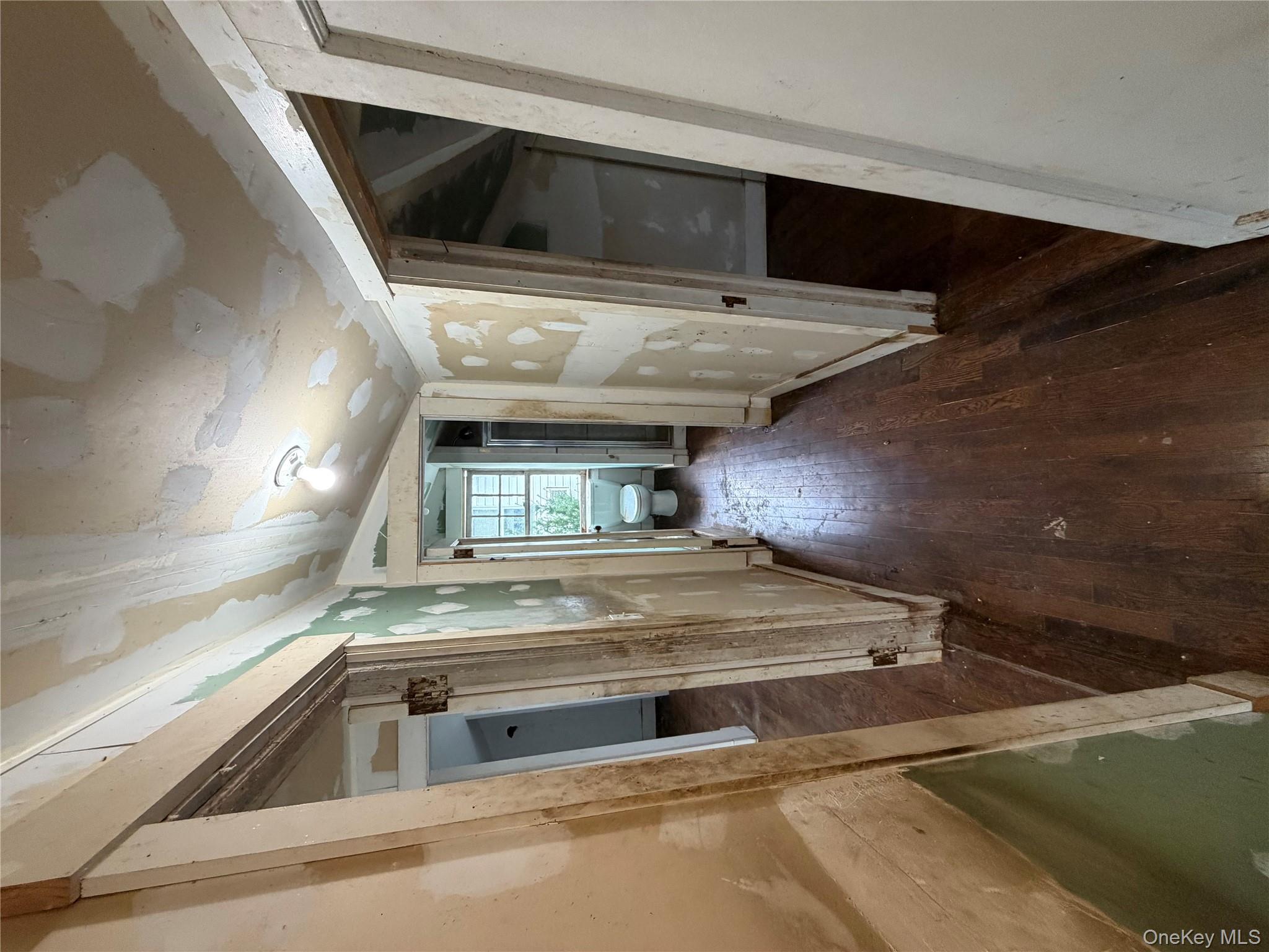 244 Tibbetts Road Yonkers, NY 10705 - Photo 8 of 28 a view of a hallway with wooden floor and staircase