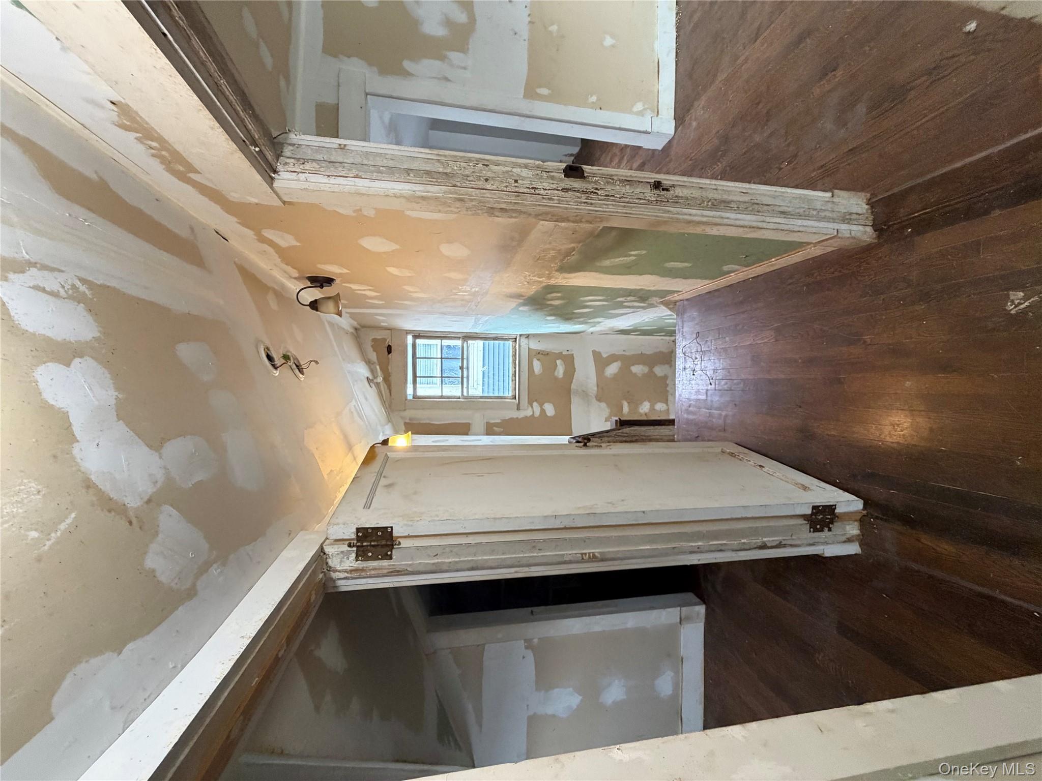 244 Tibbetts Road Yonkers, NY 10705 - Photo 9 of 28 a view of a hallway with wooden floor and staircase