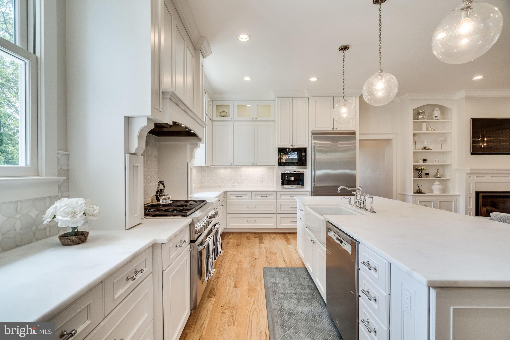 6221 Arkendale Road Alexandria, VA 22307 - Photo 13 of 60 a large kitchen with kitchen island a large counter space a sink appliances and cabinets