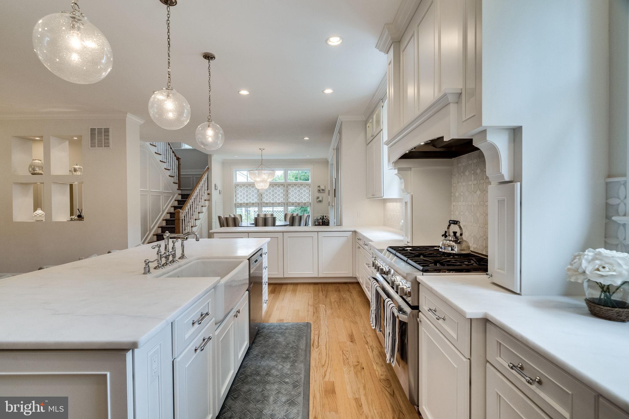 6221 Arkendale Road Alexandria, VA 22307 - Photo 15 of 60 a kitchen with kitchen island granite countertop a sink a stove and a wooden floors