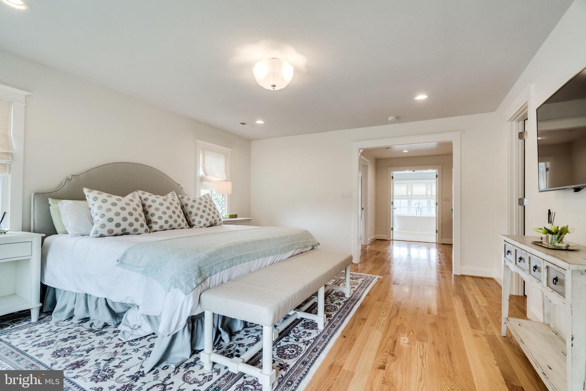 6221 Arkendale Road Alexandria, VA 22307 - Photo 25 of 60 a spacious bedroom with a bed and a view of living room