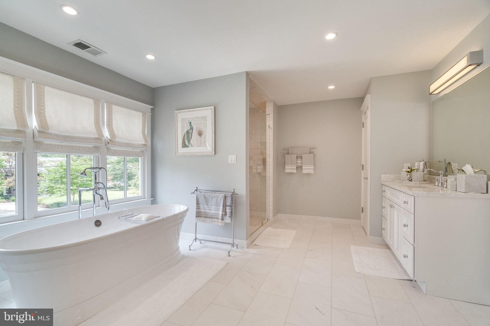 6221 Arkendale Road Alexandria, VA 22307 - Photo 27 of 60 a spacious bathroom with a double vanity sink a large mirror and a bathtub