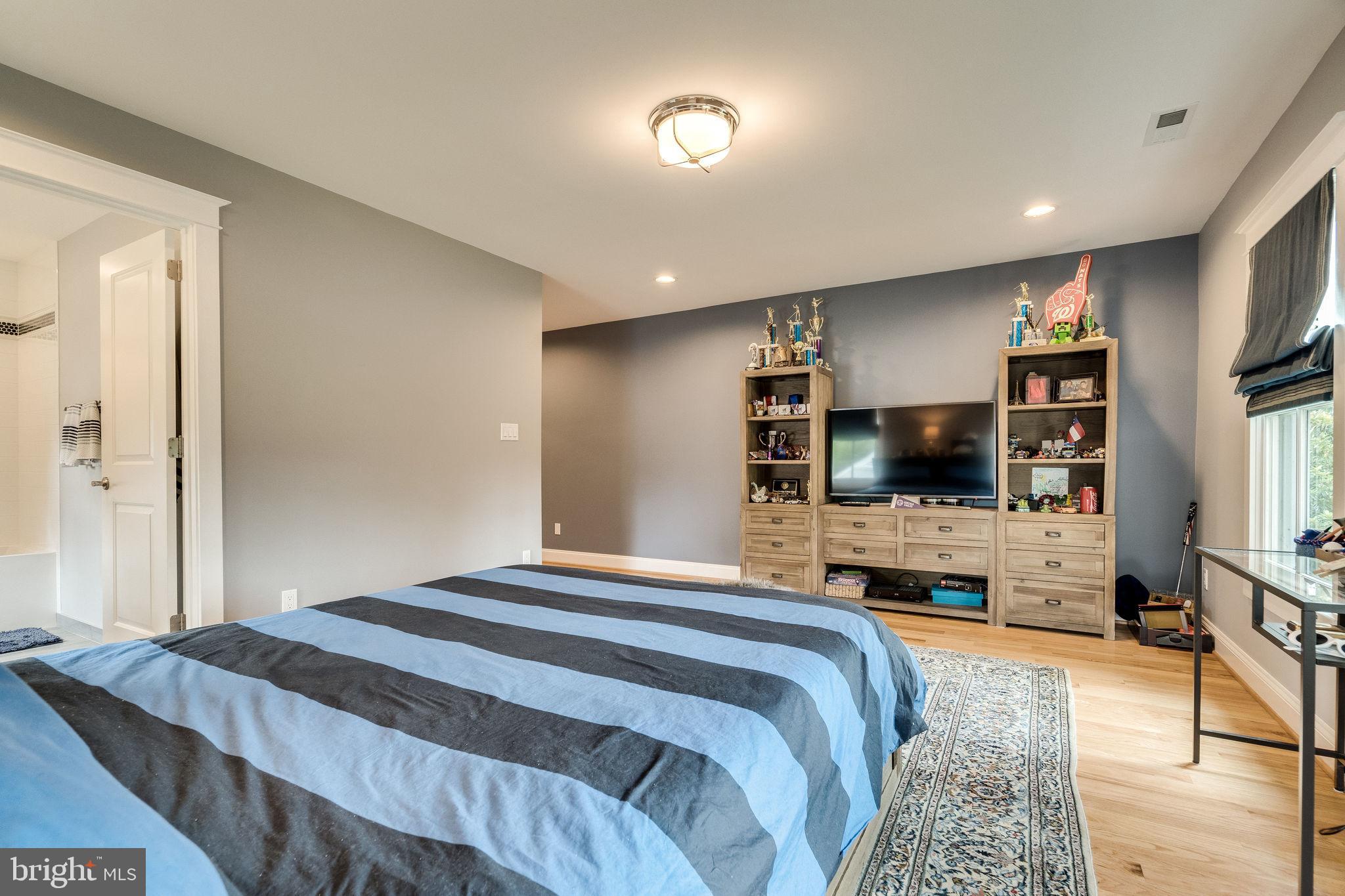 6221 Arkendale Road Alexandria, VA 22307 - Photo 35 of 60 a bedroom with a bed and a flat tv screen on wall