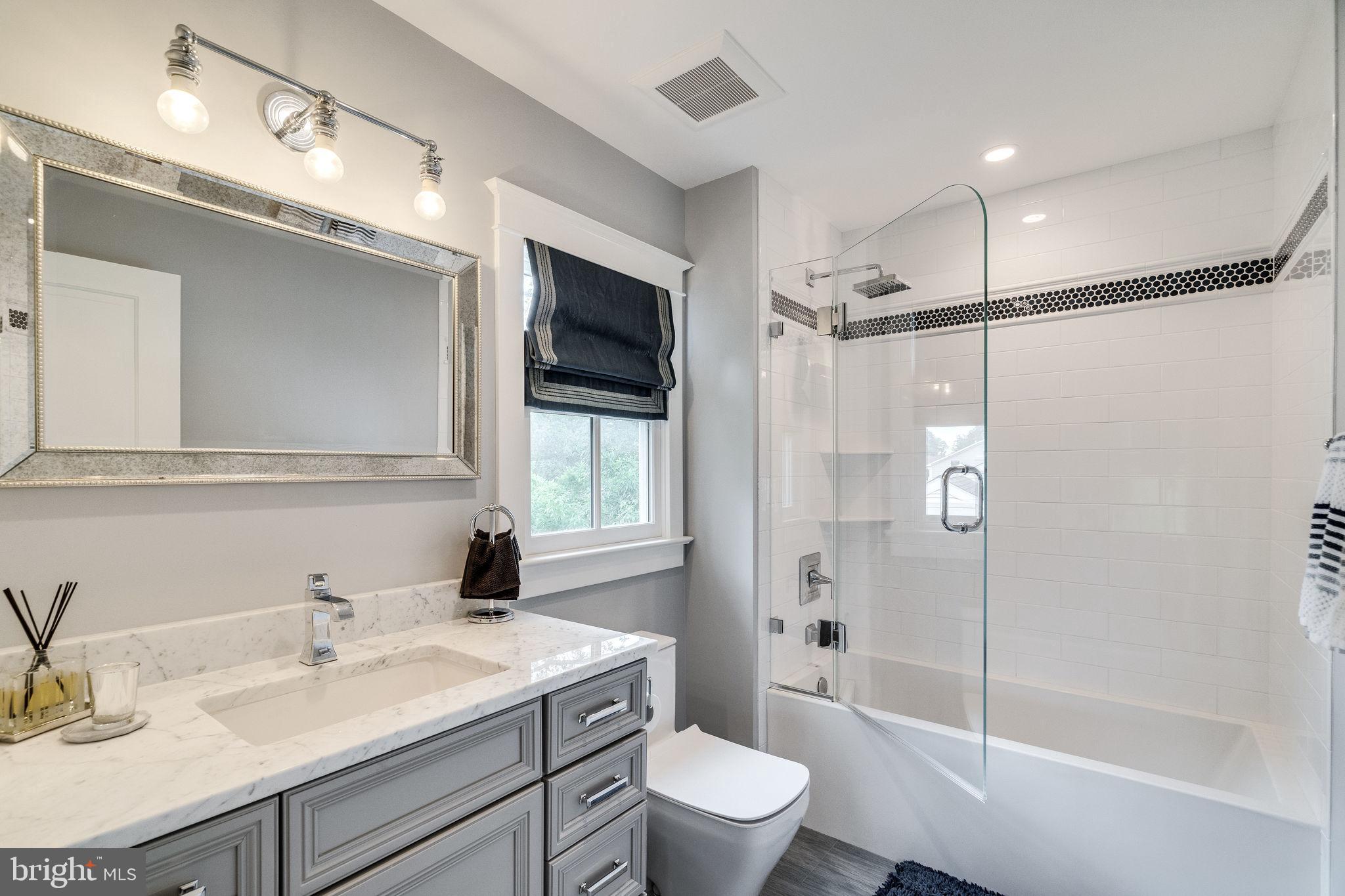6221 Arkendale Road Alexandria, VA 22307 - Photo 36 of 60 a bathroom with a sink a toilet a mirror and shower