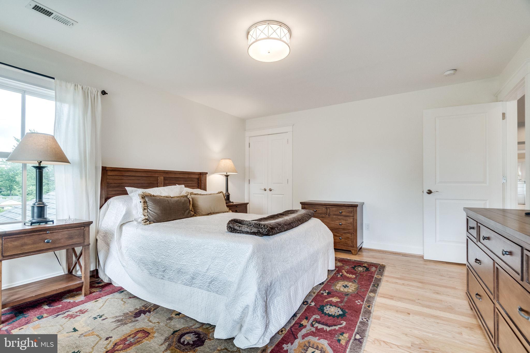 6221 Arkendale Road Alexandria, VA 22307 - Photo 38 of 60 a bedroom with a bed and a lamp