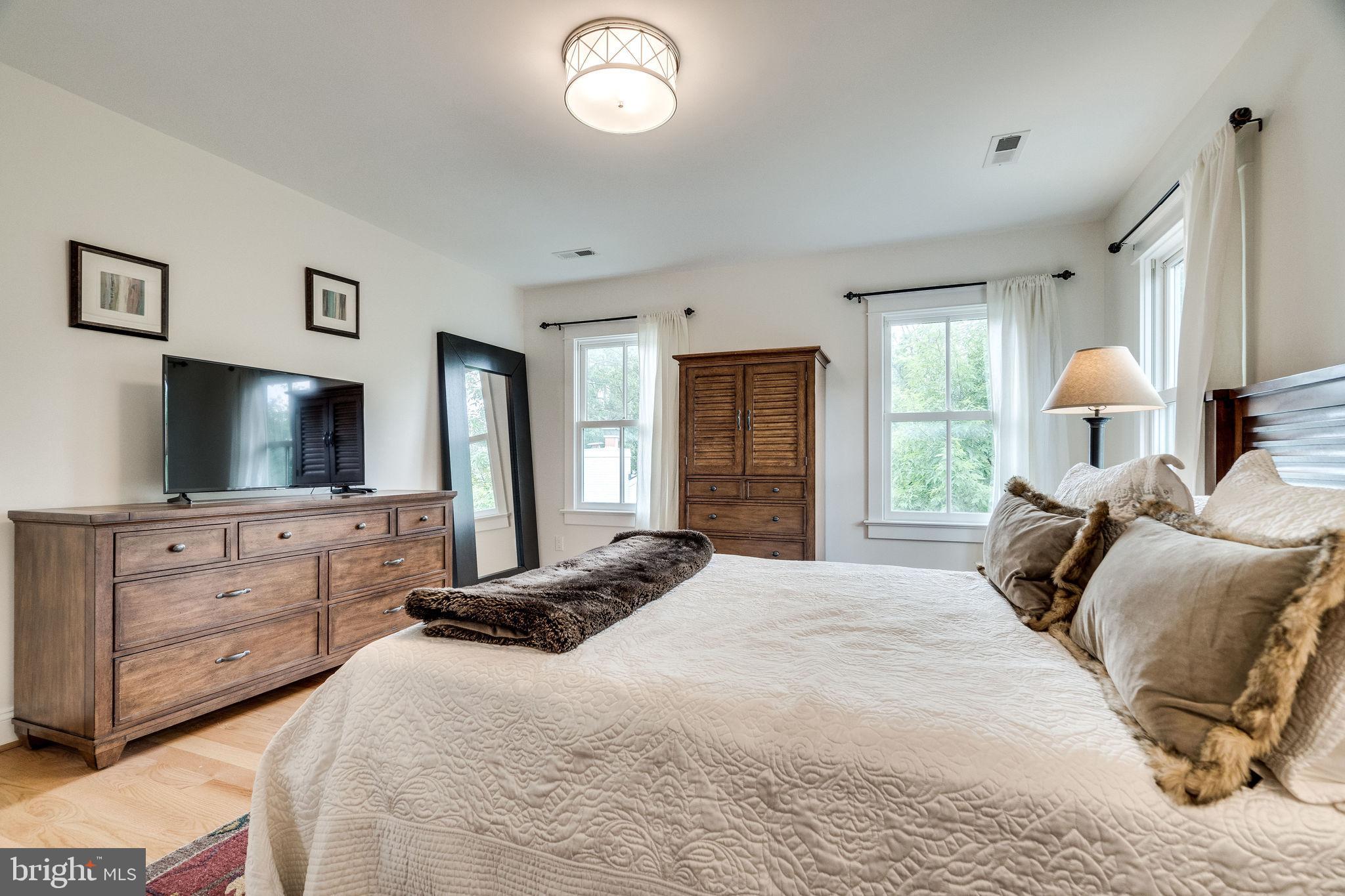 6221 Arkendale Road Alexandria, VA 22307 - Photo 39 of 60 a bedroom with a bed and a flat screen tv