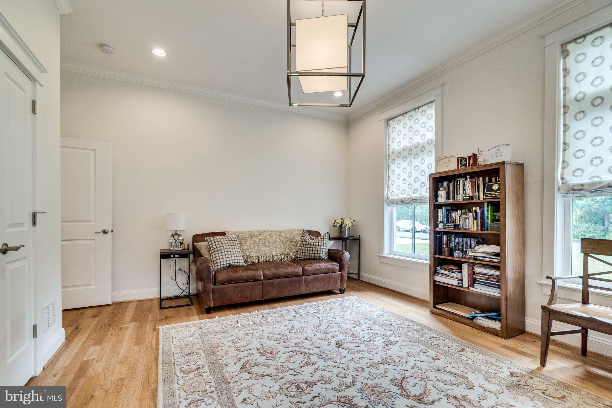 6221 Arkendale Road Alexandria, VA 22307 - Photo 48 of 60 a living room with furniture and a book shelf