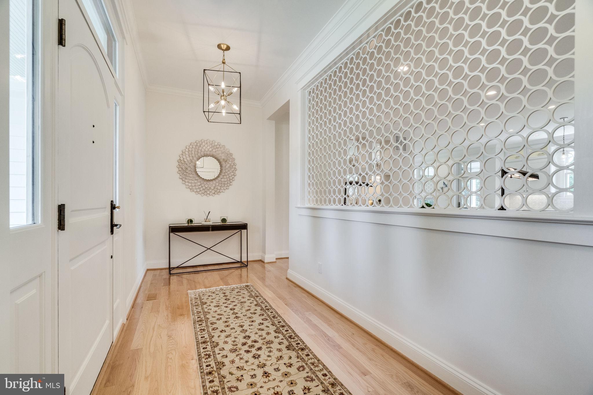 6221 Arkendale Road Alexandria, VA 22307 - Photo 6 of 60 a view of a hallway with wooden floor and a bathroom