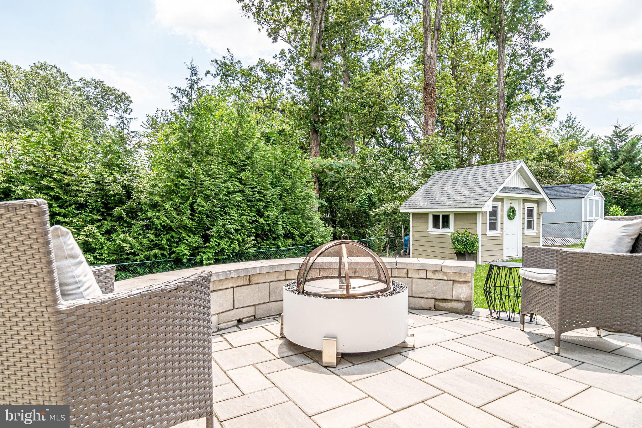 6221 Arkendale Road Alexandria, VA 22307 - Photo 57 of 60 a view of a patio with table and chairs potted plants and large tree