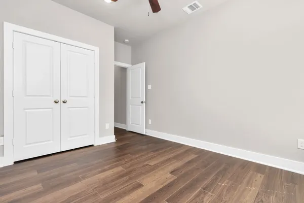 a view of an empty room with wooden floor