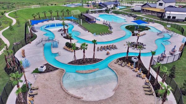 an aerial view of a swimming pool patio and outdoor seating