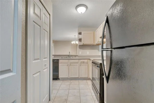 a kitchen with a refrigerator and a sink