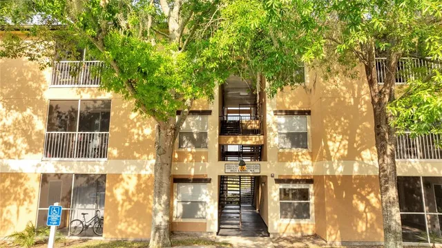a front view of a building with a tree