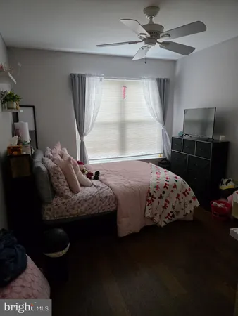 a bedroom with a bed and dresser with mirror