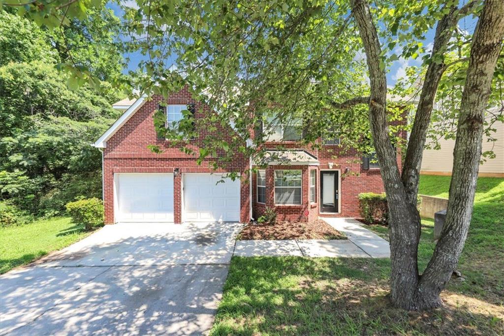 a front view of a house with a yard
