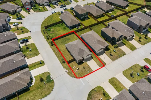 an aerial view of a house with a swimming pool