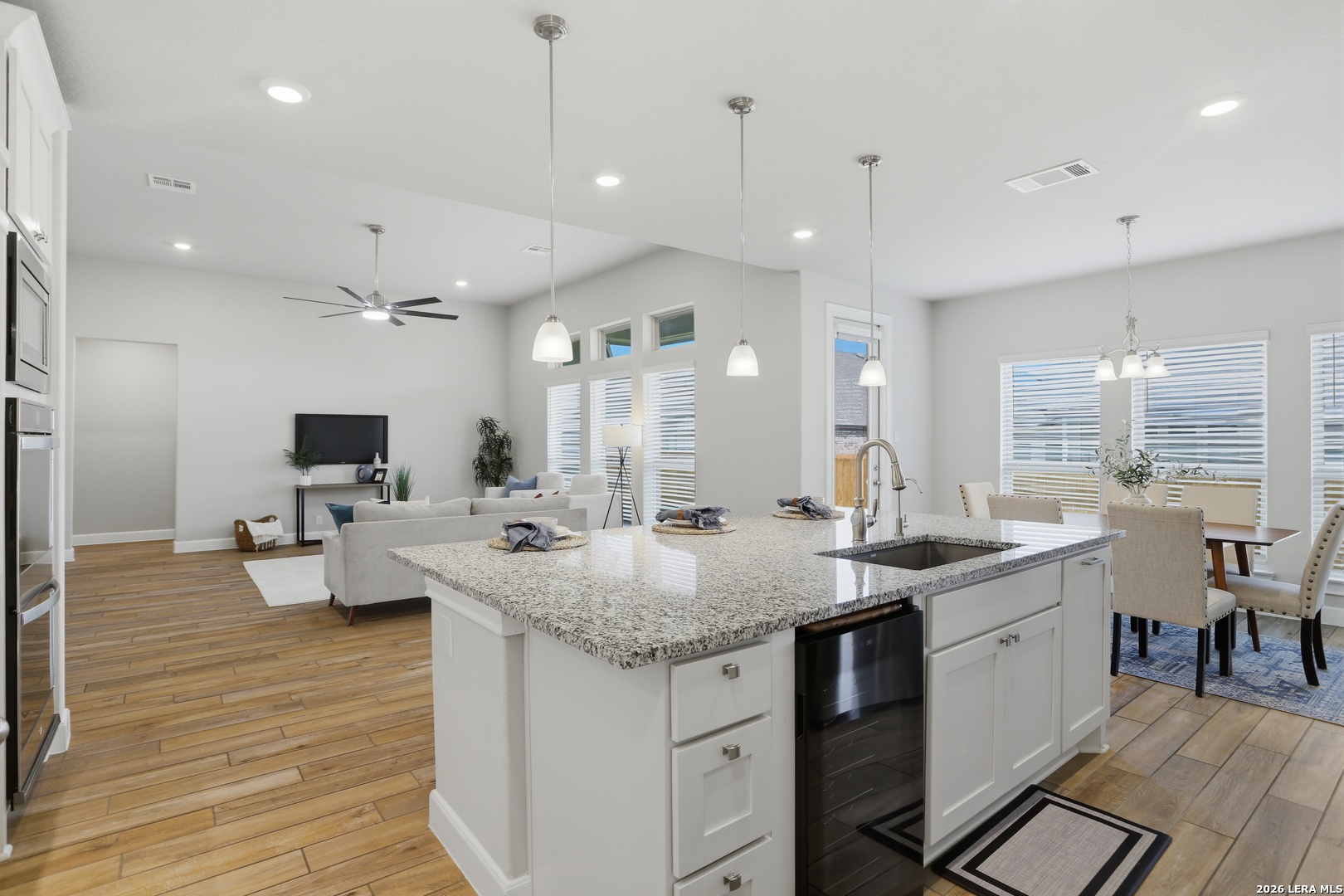 337 Misty Sails Cibolo, TX 78108 - Photo 14 of 50 a kitchen with sink stove and view living room with wooden floor