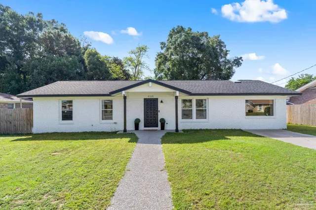 a view of a house with a yard and plants