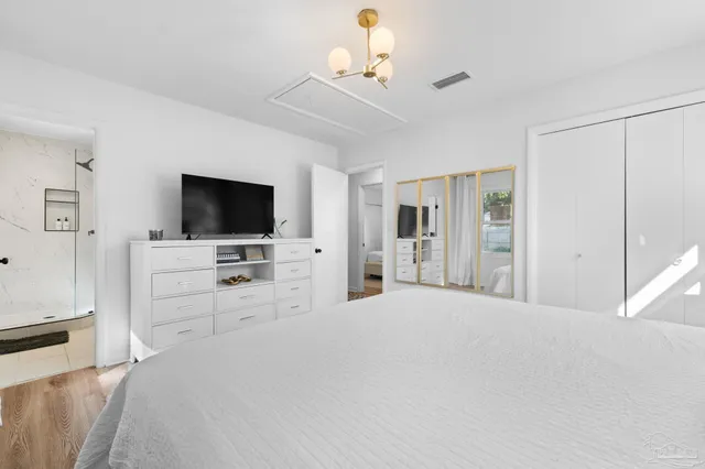 a large bedroom with a flat screen television and a bed