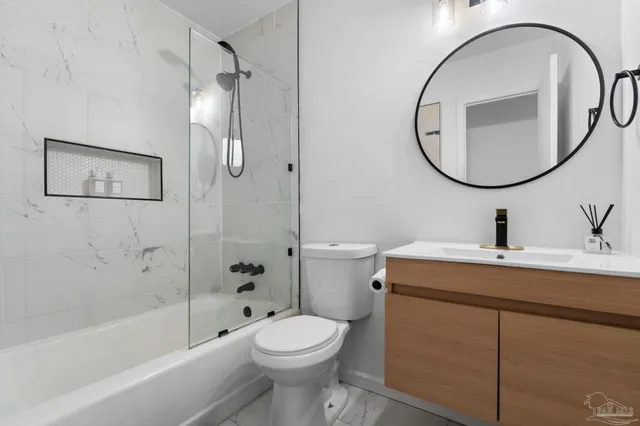 a bathroom with a sink a toilet and a mirror