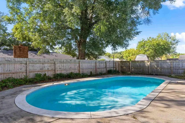 a view of a swimming pool with a yard