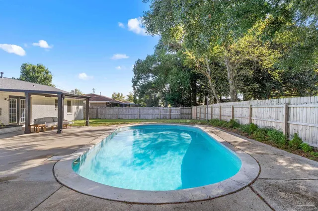 a view of a swimming pool with a patio