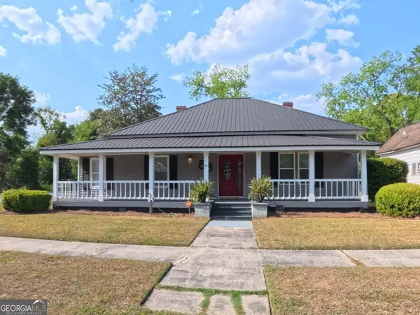 a front view of a house with a yard outdoor seating and barbeque oven