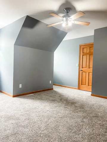 en empty room with windows and fan