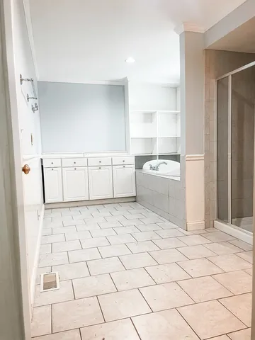 a room with a white cabinets and window