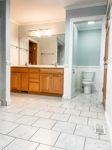 a bathroom with a sink a mirror and a toilet