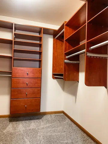 a view of walk in closet with empty racks