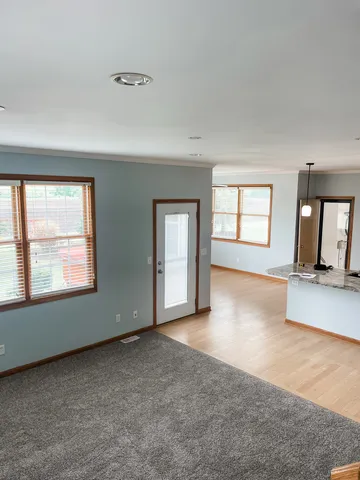 an empty room with a window and fireplace