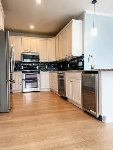 a kitchen with stainless steel appliances granite countertop a stove and a sink
