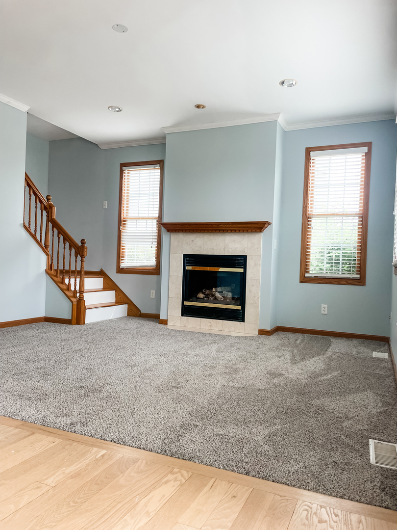 1308 Axcel Lane Sycamore, IL 60178 - Photo 6 of 34 a view of an empty room with wooden floor fireplace and a window
