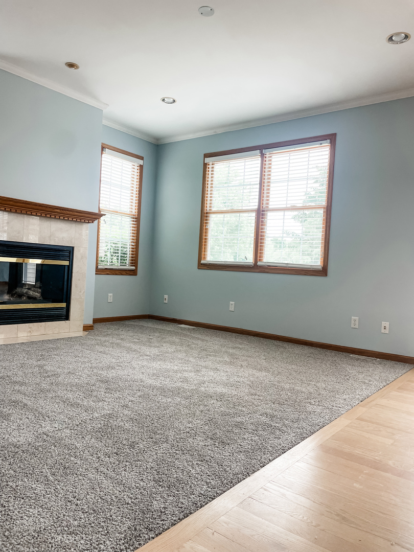 1308 Axcel Lane Sycamore, IL 60178 - Photo 7 of 34 an empty room with windows and fireplace