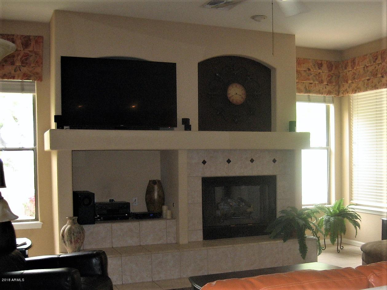 13382 West Coronado Road Goodyear, AZ 85395 - Photo 14 of 35 family room with gas fireplace