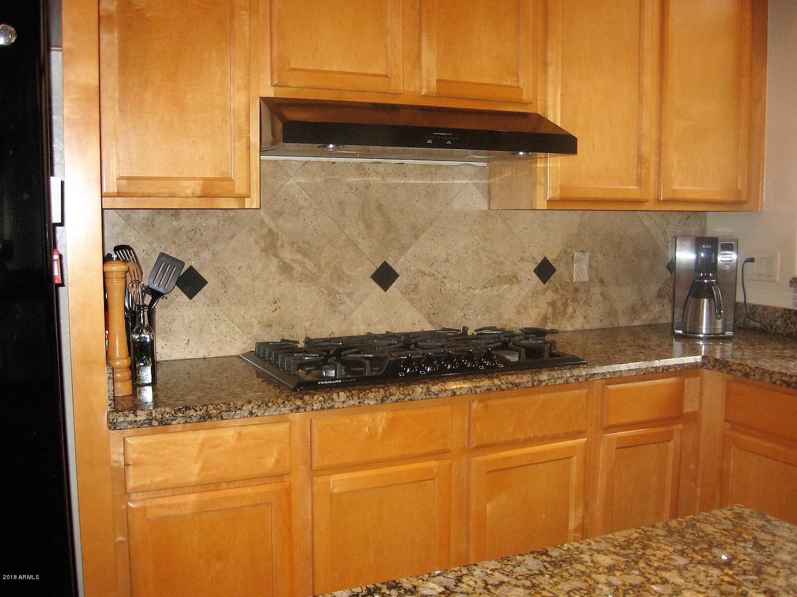 13382 West Coronado Road Goodyear, AZ 85395 - Photo 10 of 35 gas stove top travertine backsplash