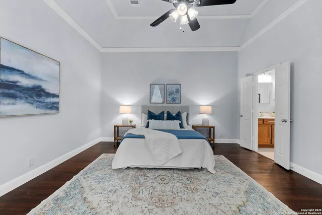 a spacious bedroom with a bed and a chandelier