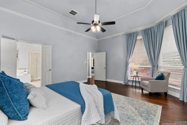 a bedroom with a bed and a large window