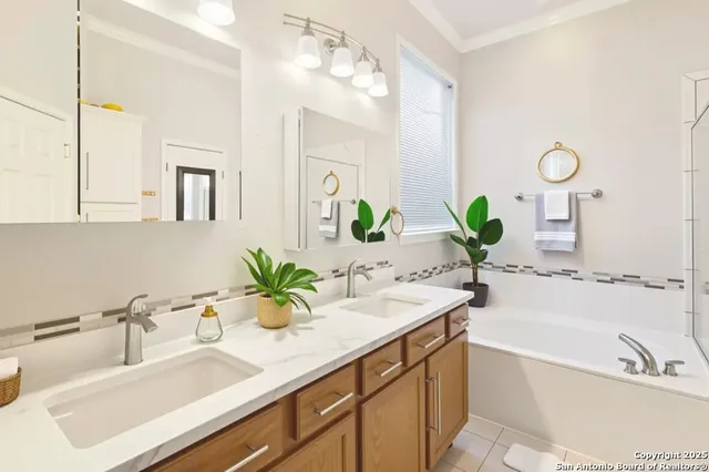 a bathroom with a tub sink and mirror