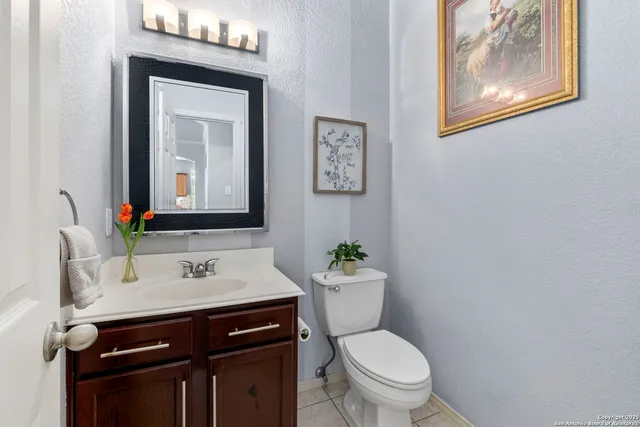 a bathroom with a toilet a sink and mirror