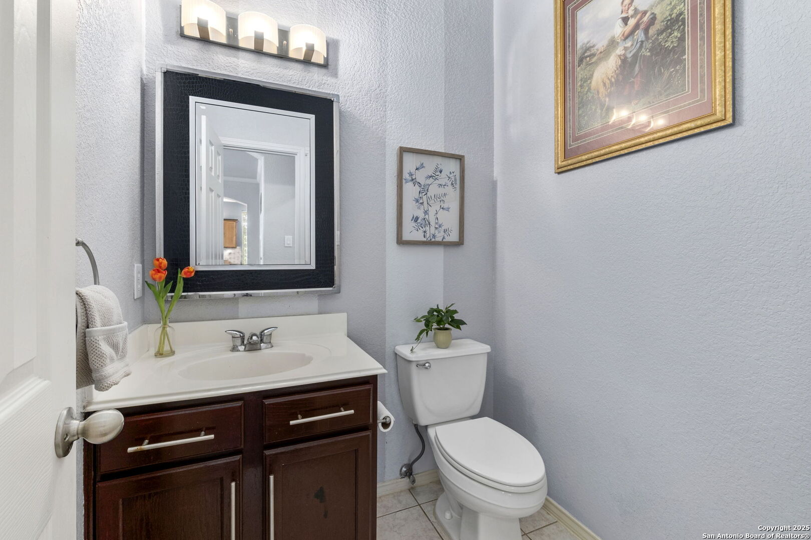 8607 Solano Drive Helotes, TX 78023 - Photo 17 of 30 a bathroom with a toilet a sink and mirror