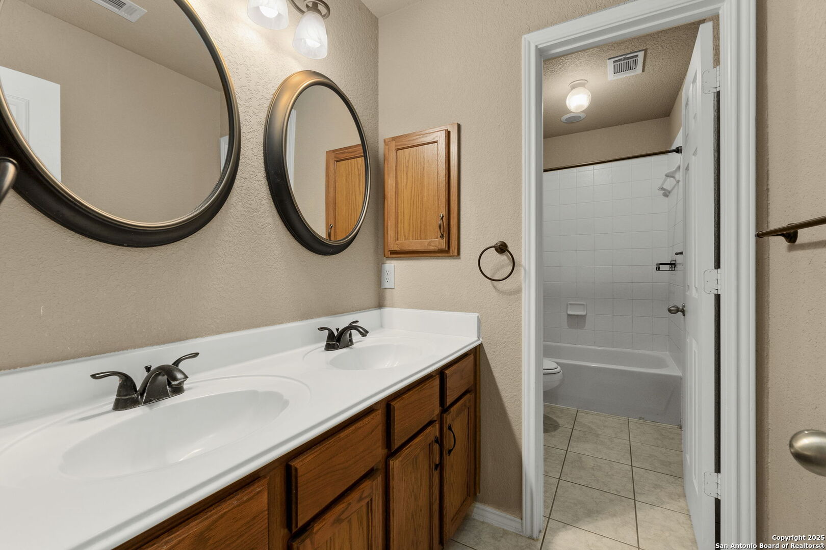 8607 Solano Drive Helotes, TX 78023 - Photo 20 of 30 a bathroom with a sink and a mirror