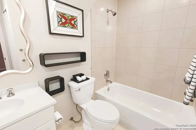 a white toilet sitting next to a bathroom sink and tub