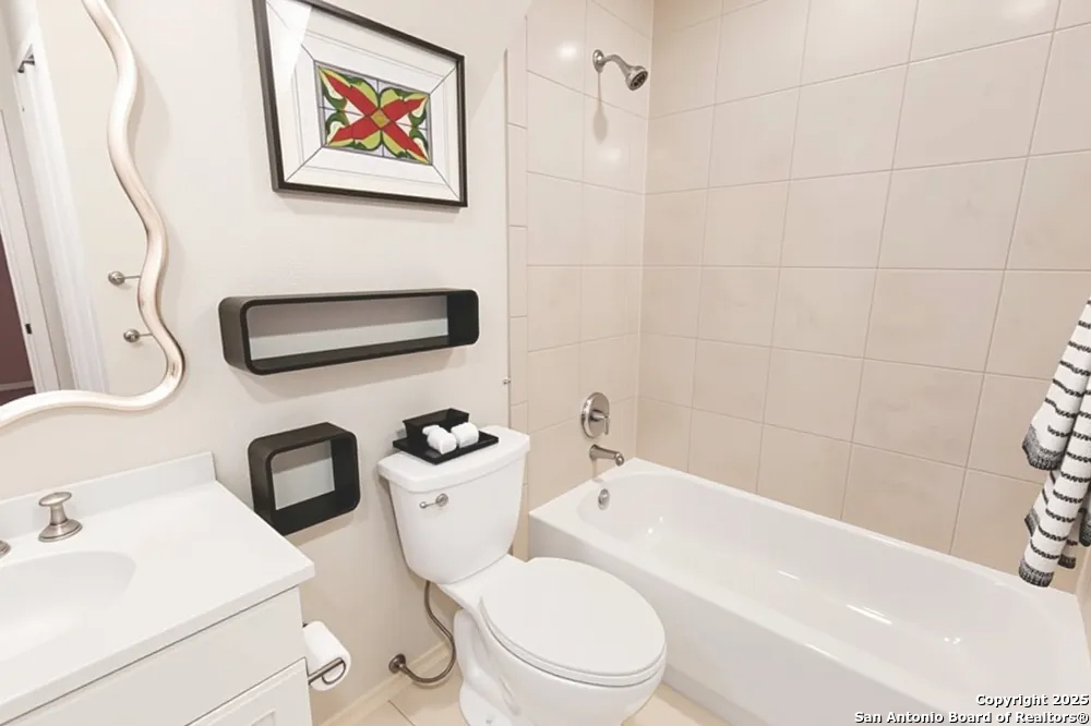 8607 Solano Drive Helotes, TX 78023 - Photo 22 of 30 a white toilet sitting next to a bathroom sink and tub