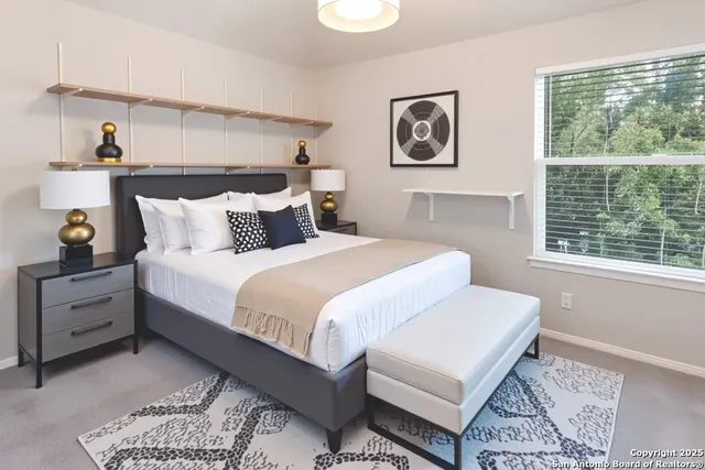 a bedroom with a large bed and a window