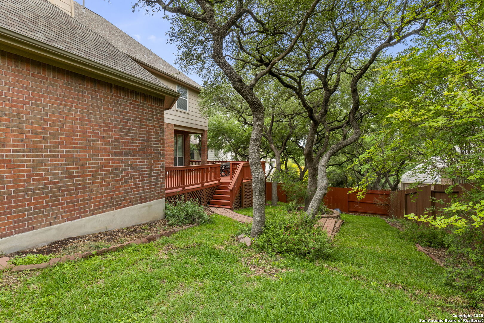 8607 Solano Drive Helotes, TX 78023 - Photo 28 of 30 a view of backyard with plants and large tree