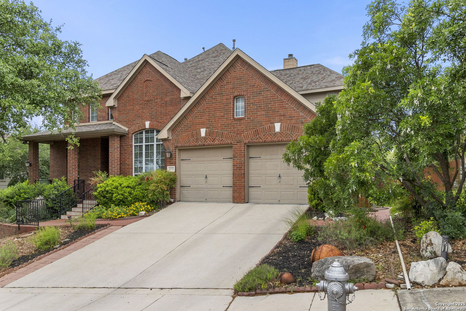 8607 Solano Drive Helotes, TX 78023 - Photo 3 of 30 a front view of a house with a yard and potted plants
