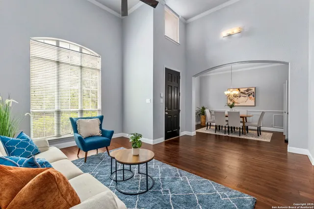 a living room with furniture and wooden floor